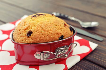 Freshly baked cranberry muffin in shape of heart.の写真素材