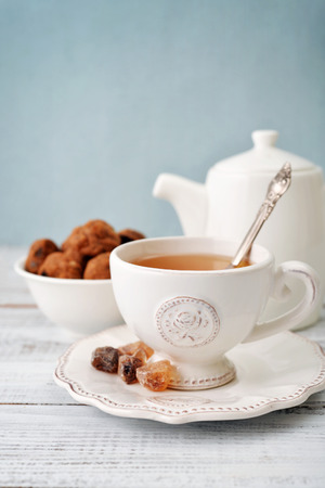 Cup of tea and sugar with cookies  over blue backgroundの写真素材