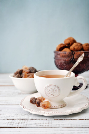 Cup of tea and sugar with cookies  over blue backgroundの写真素材