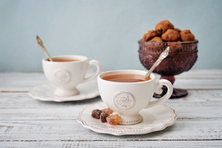 Cups of tea and sugar with cookies  over blue backgroundの写真素材