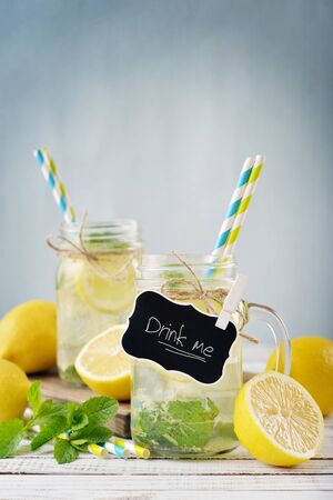 Lemonade with citrus and tag in jars with handles closeupの写真素材