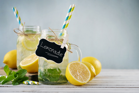 Lemonade with citrus and tag in jars with handles closeupの写真素材