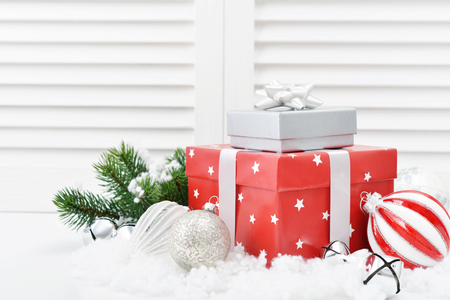 Christmas decorations with gift box and fir tree on white wooden backgroundの写真素材