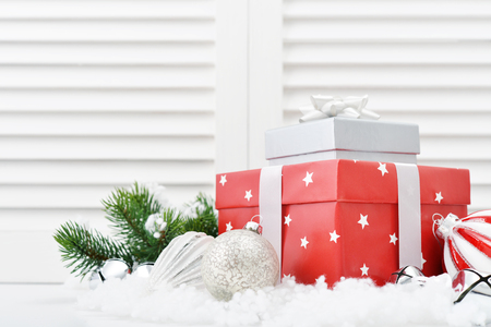 Christmas decorations with gift box and fir tree on white wooden backgroundの写真素材