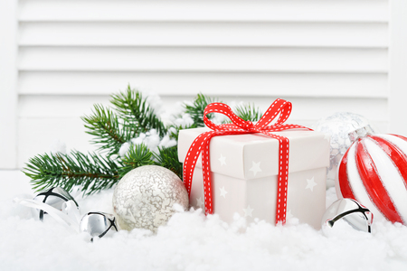 Gift boxes with christmas decorations and fir tree on white wooden backgroundの写真素材