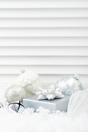 Gift box with christmas decorations  on white wooden backgroundの写真素材