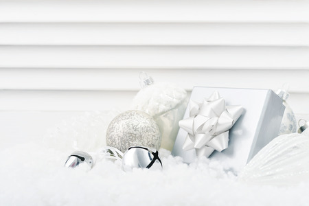 Gift box with christmas decorations  on white wooden backgroundの写真素材