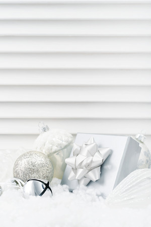 Gift box with christmas decorations  on white wooden backgroundの写真素材