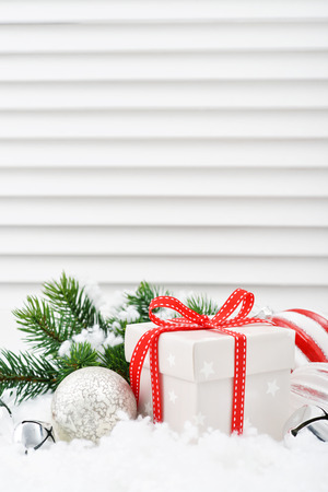 Gift boxes with christmas decorations and fir tree on white wooden backgroundの写真素材