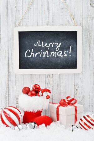 Slate board with Christmas decoration on light wooden backgroundの写真素材