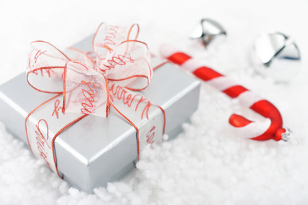Gift box with ribbon and christmas decorations on light background closeupの写真素材