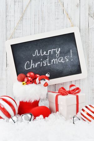 Slate board with Christmas decorations on light wooden backgroundの写真素材
