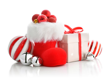 Red Santa's boots with christmas decorations isolated on white backgroundの写真素材