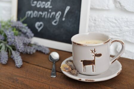 Cup of coffee with blackboard on wooden backgroundの写真素材