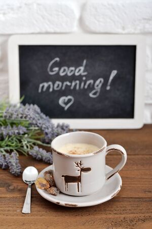 Cup of coffee with blackboard on wooden backgroundの写真素材