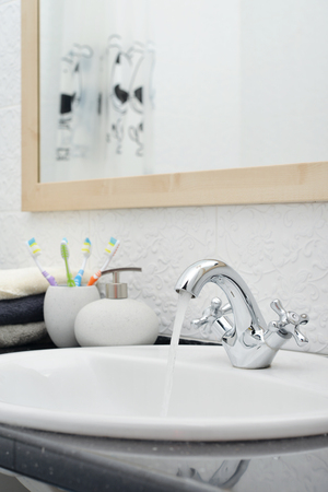 Working mixer tap in the bathroom closeupの写真素材