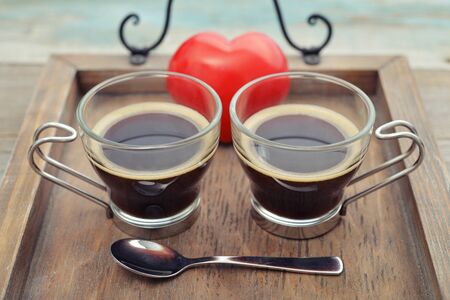 Two glass cups of coffee on wooden trayの写真素材