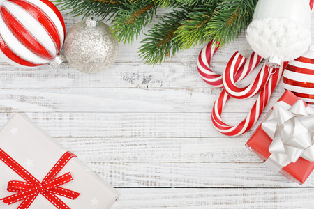 Christmas decorations with fir tree and gift boxes on wooden backgroundの写真素材