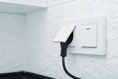 Electric plug in a socket closeup. Small shallow DOFの写真素材