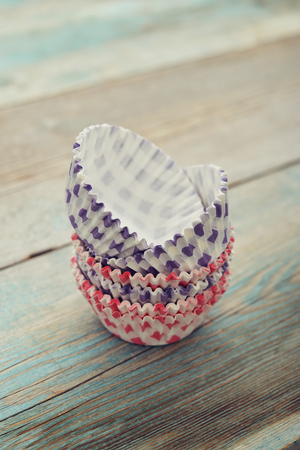 Paper cupcake cases on wooden backgroundの写真素材