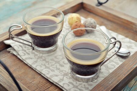Two glass cups of coffee on wooden trayの写真素材