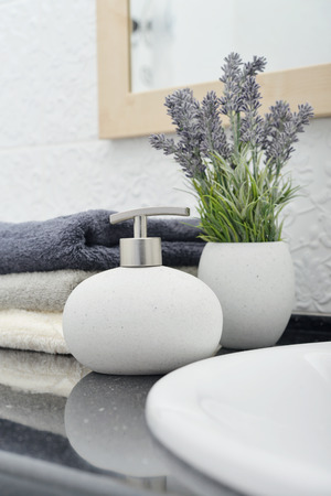 Soap dispenser with a stack of towels in a bathroom closeupの写真素材