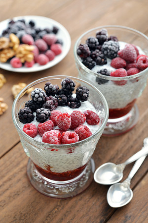 Pudding with chia seeds, yogurt and frozen berries in glassの写真素材
