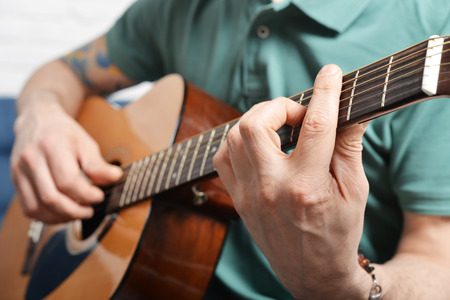 Closeup of fingers from playing acoustic guitarの写真素材