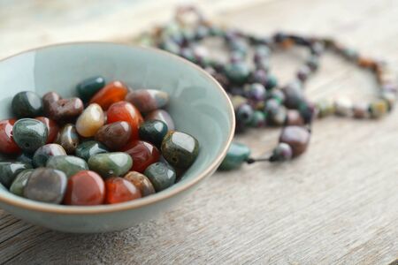 Beautiful semiprecious stone beads on wooden background closeupの写真素材