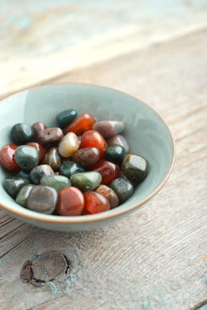 Beautiful semiprecious stone beads on wooden background closeupの写真素材