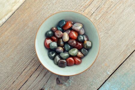 Beautiful semiprecious stone beads on wooden background closeupの写真素材