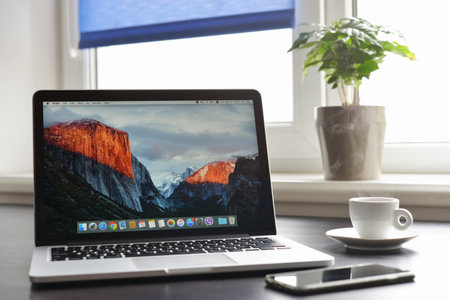 Kiev, Ukraine - May 15, 2016:Brand new Macbook Pro with with Retina display and OS X EL Capitan on table. MacBook is a brand of notebook computers manufactured by Apple Inc.のeditorial素材