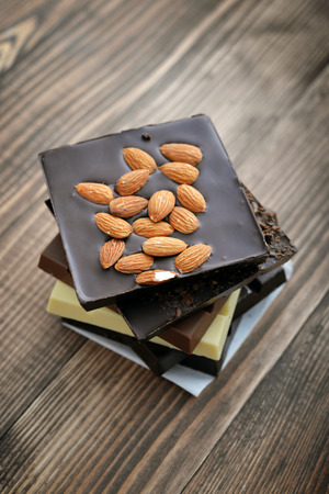 Chocolate bar from different kind of chocolate (milk, black, white) on  wooden backgroundの写真素材