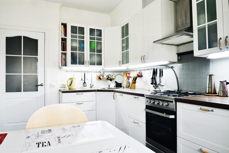 Interior of the kitchen in Scandinavian style with white furniture and a dining tableの写真素材