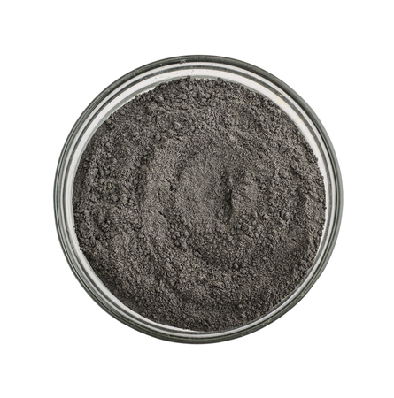 Black cosmetic clay powder in glass bowl isolated on white background,の写真素材