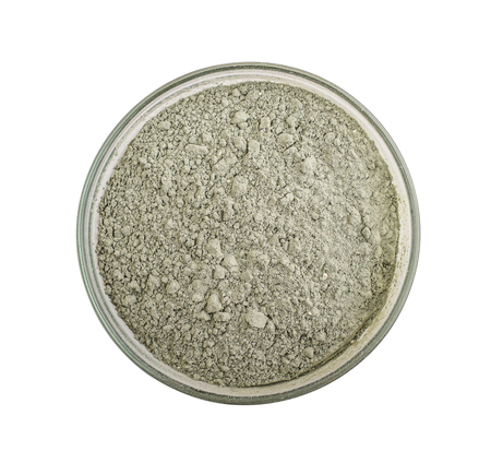 Green cosmetic clay powder in glass bowl isolated on white background, with clipping pathの写真素材