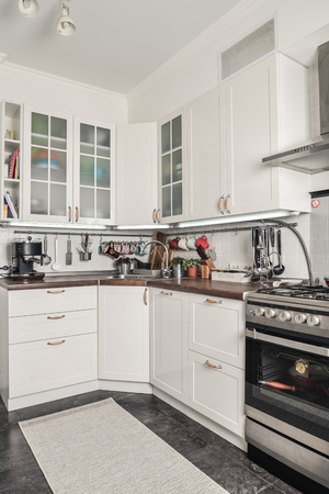 Interior of the kitchen in Scandinavian style with white furniture and a dining table. 
の写真素材