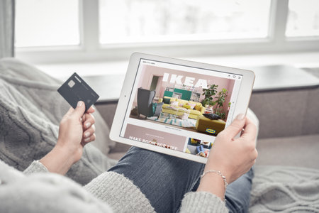 Kiev, Ukrain - February 10, 2018: Woman using IKEA app on a brand new Apple iPad Pro Silver to order furniture. IKEA was founded in of Sweden in 1943, IKEA to have large chain stores around the world.のeditorial素材