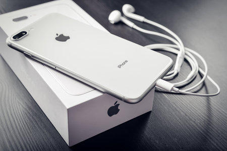 Kyiv, Ukraine - January 24, 2018:Unpacked new Apple iPhone 8 Plus Silver  on black wooden background. IPhone 8 Plus was created and developed by the Apple inc.のeditorial素材
