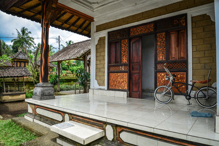 BALI, INDONESIA - JANUARY 9, 2018: Traditional Balinese house, porch with vintage cycle on Bali, Indonesiaのeditorial素材