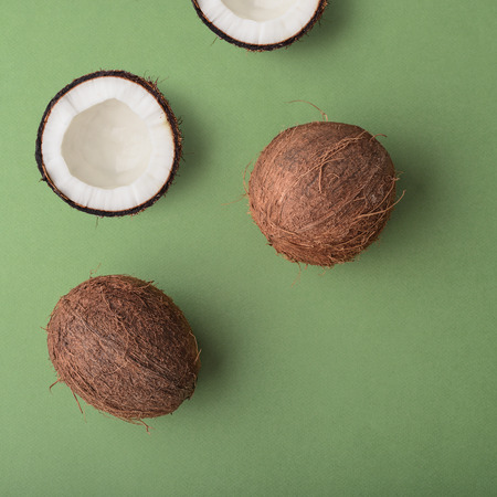 Tropical abstract background. Coconuts on the green background. Top view.の写真素材