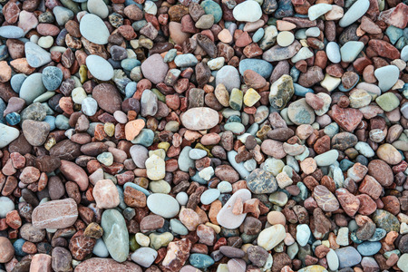 Colorful wet sea stones on beach, top view. May used as background.の写真素材