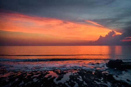 Coastline near the Tanah Lot Temple, the most important indu temple of Bali, Indonesia at sunsetの写真素材