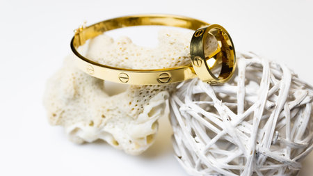 golden bracelet with a ring on a white background, jewelry conceptの写真素材