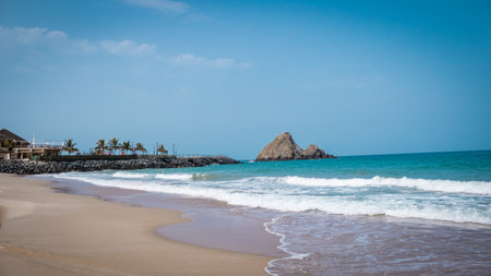 Beach and rocks on the background of the sea and blue skyの写真素材