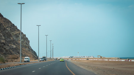 Driving on the highway through the desert mountains. Toned.の写真素材