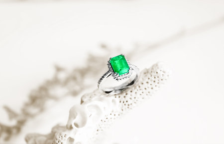 Jewelry ring with green emerald on a white background.の写真素材