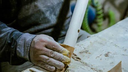 carpenter using nail gun or brad nailer tool on wood box in a workshop ,furniture restoration...