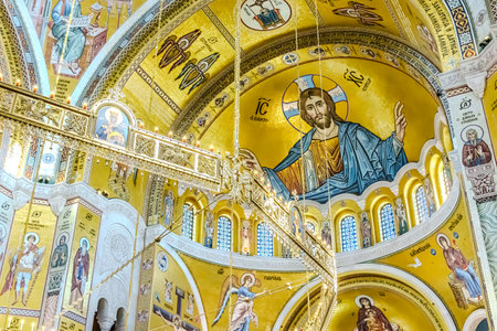 people pray in an Orthodox church, frescoes on the ceilings and walls of the church. High quality...