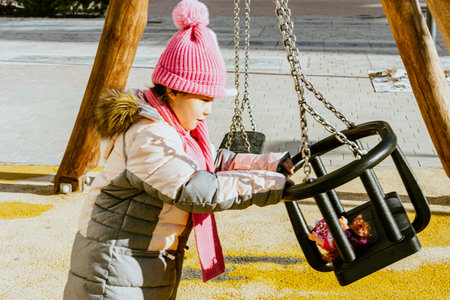 girl playing educational games on playground in winter. High quality photoの写真素材
